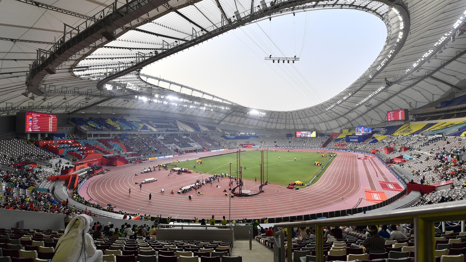 Spectators watch the women&#039;s 200 meter heats on the fourth day of the World Athletics Championships in Doha, Qatar, Monday, Sept. 30, 2019. (AP Photo/Martin Meissner)