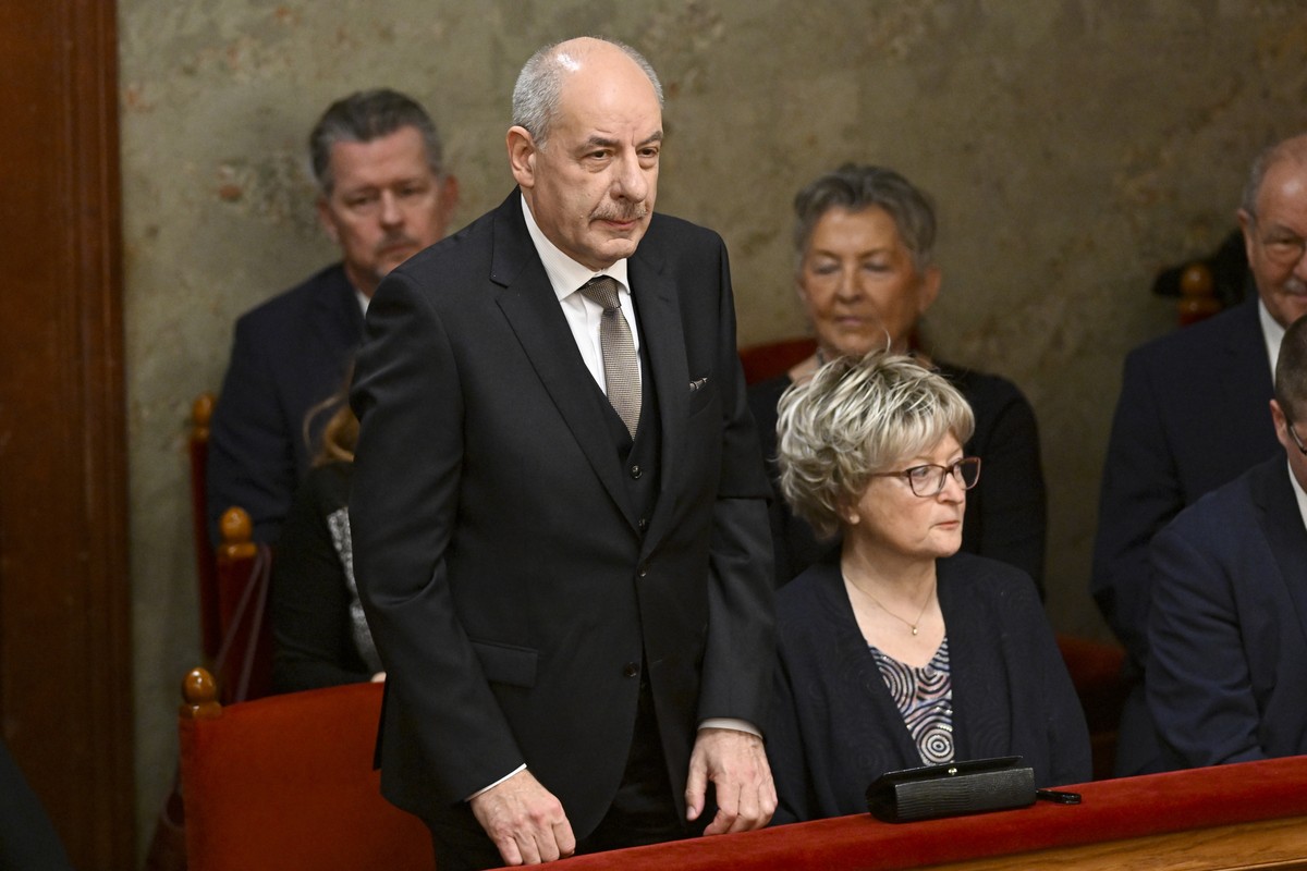 Tamas Sulyok, left, the head of Hungary's Constitutional Court, stands before a parliament vote to elect him as president, in Budapest, Hungary, Monday, Feb 26, 2024. Hungary's former presid ...