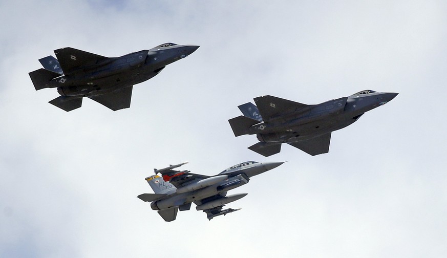 An F-16, below, escorts two F-35 jets, above, after arriving at it new operational base Wednesday, Sept. 2, 2015, at Hill Air Force Base, in northern Utah. Two F-35 jets touched down Wednesday afterno ...