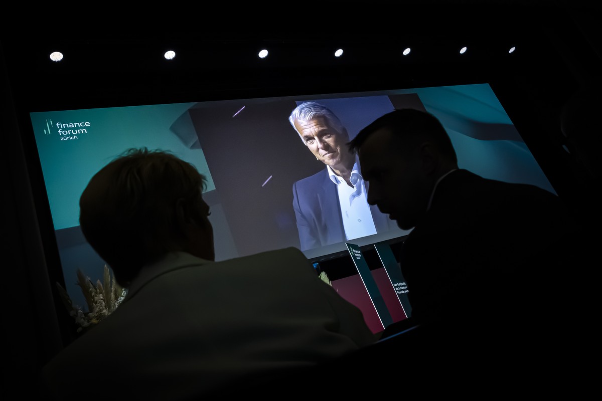 Swiss Finance Minister and Federal Councillor Karin Keller-Sutter, left, speaks to her personal assistant Christian Steiner, right, as Sergio P. Ermotti, Group Chief Executive Officer of Swiss bank UB ...