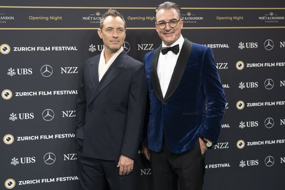 epa11640423 British actor Jude Law (L) and ZFF Artistic Director Christian Jungen arrive on the green carpet for the Opening Night of the 20th Zurich Film Festival (ZFF), in Zurich, Switzerland, 03 Oc ...