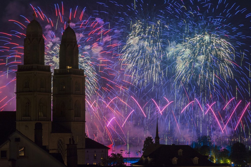 Fireworks illuminate the sky next to the Grossmuenster cathedral during the Zurich festival in Zurich, Switzerland, Friday, July 1, 2016. The Zurich Festival attracts almost two million people during  ...