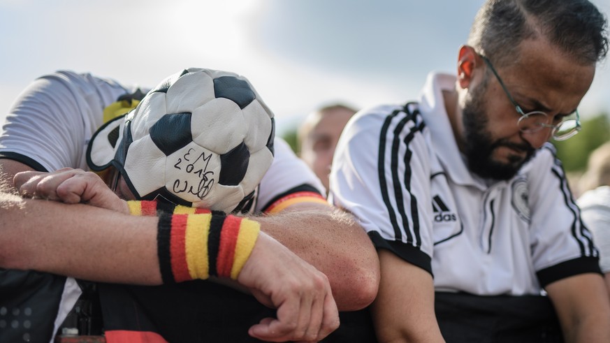 epa06816189 German fans react to the first goal of Mexico in the FIFA World Cup 2018 match between Germany and Mexico during a public viewing in front of the Brandenburg Gate in Berlin, Germany, 17 Ju ...