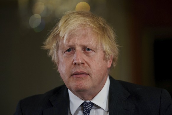 FILE - British Prime Minister Boris Johnson records an address to the nation at Downing Street, London, to provide an update on the booster vaccine programme, Sunday, Dec. 12, 2021. Lawmakers are expe ...