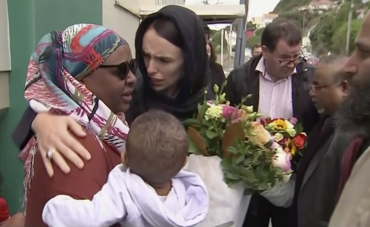 In this image made from video, New Zealand's Prime Minister Jacinda Ardern, center, hugs and consoles a woman as she visited Kilbirnie Mosque to lay flowers among tributes to Christchurch attack  ...
