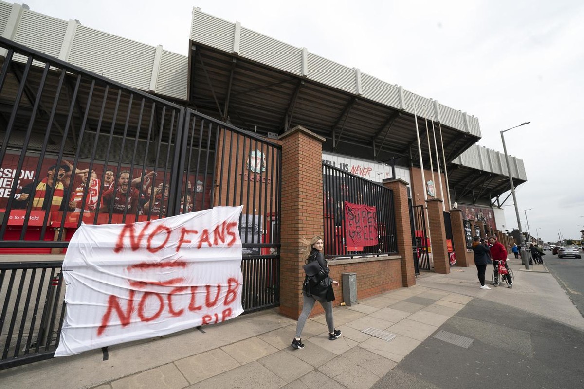 Banners are seen outside Liverpool's Anfield Stadium after the collapse of English involvement in the proposed European Super League, Liverpool, England, Wednesday, April 21, 2021. Liverpool owne ...
