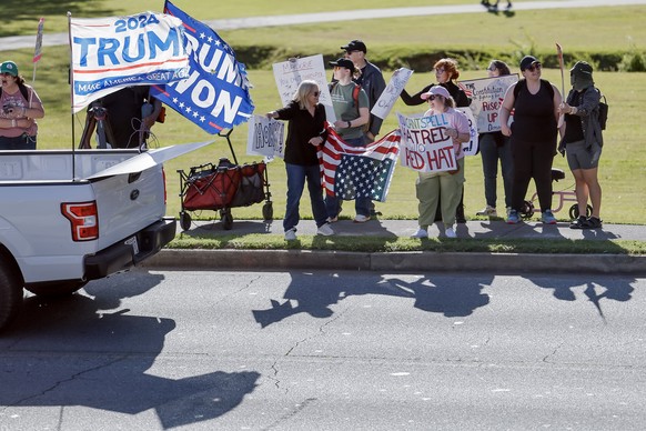 epa12034121 Demonstrators protest outside as Republican Representative from Georgia Marjorie Taylor Greene participates in her Cobb County Town Hall at the Acworth Community Center in Acworth, Georgia ...