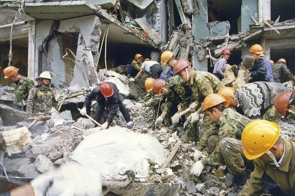 FILE - Rescue workers shuffle the rubble at a devastated apartment building in the city of Volgodonsk, close to Russia&#039;s Caucasus Mountains region, Thursday, Sept. 16, 1999. The attack on a Mosco ...