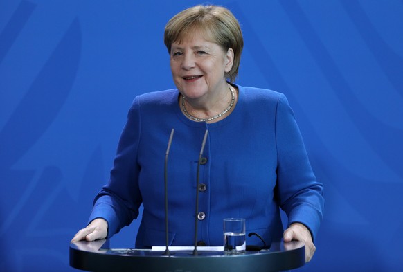 epa08046599 German Chancellor Angela Merkel reacts to a question while standing next to Kazakh President Kassym-Jomart Tokayev (not pitured) during a joint press conference after their meeting in the  ...