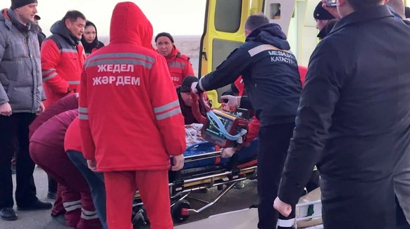 In this photo taken from a video released by the administration of Mangystau region, rescuers prepare to carry a wounded passenger near the Kazakhstani city of Aktau, Thursday, Dec. 26 , 2024, after a ...
