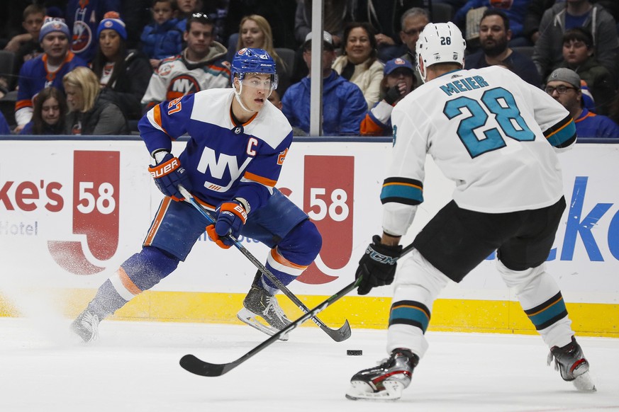 New York Islanders left wing Anders Lee (27) looks to pass against San Jose Sharks right wing Timo Meier (28) during the second period of an NHL hockey game, Sunday, Feb. 23, 2020, in Uniondale, NY. ( ...