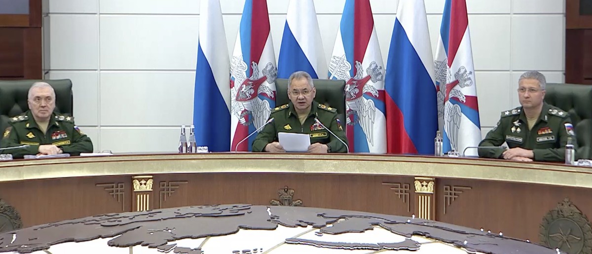 epa10702474 A handout photo made available by the Russian Defence ministry press-service shows Russian Defence Minister General of the Army Sergei Shoigu (C) delivers his speech during a meeting of th ...