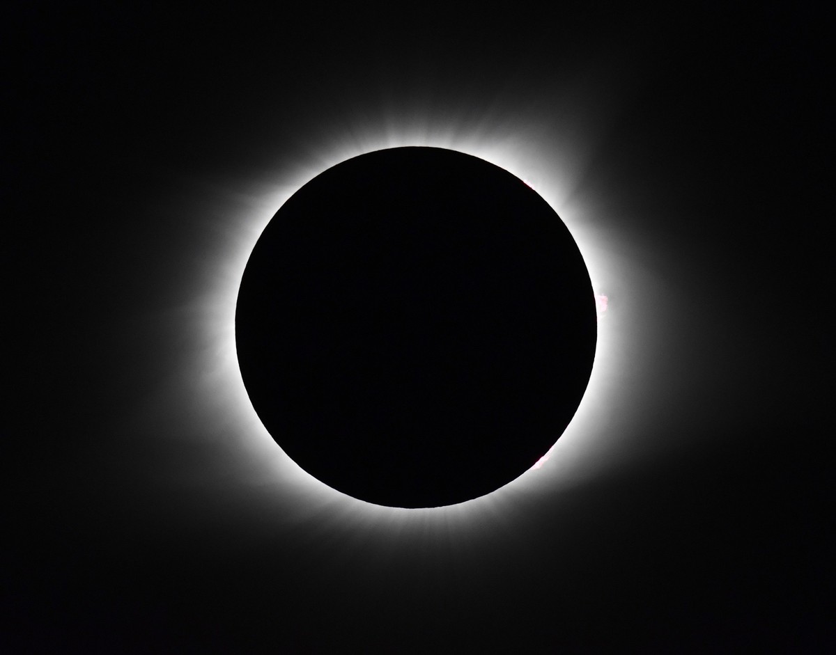 The moon covers the sun as it creates a total eclipse, Monday, August. 21, 2017, in Cerulean, Ky. At the 3 o'clock position is a prominent solar flare. (AP Photo/Timothy D. Easley)