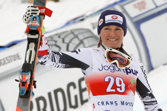 Andrea Fischbacher of Austria celebrates winning the women&#039;s FIS Alpine Skiing World Cup Downhill race on her way to the podium in the Swiss resort of Crans Montana March 2, 2014. REUTERS/Ruben S ...