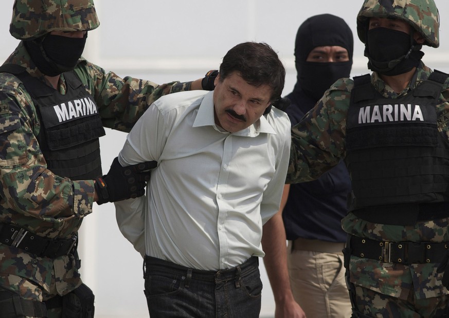 FILE - In this Feb. 22, 2014, file photo, Joaquin &quot;El Chapo&quot; Guzman is escorted to a helicopter in handcuffs by Mexican navy marines at a navy hanger in Mexico City, Mexico. A U.S. judge has ...