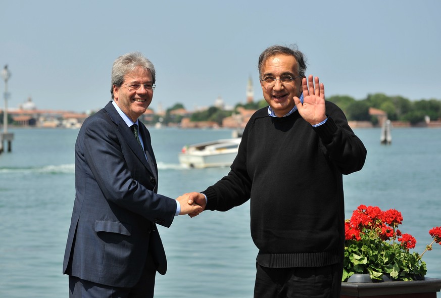 Fiat and Chrysler CEO Sergio Marchionne, right, shakes hands with Italian Foreign Minister Paolo Gentiloni as they arrive on the occasion of the 25th meeting of The Council for the United States and I ...