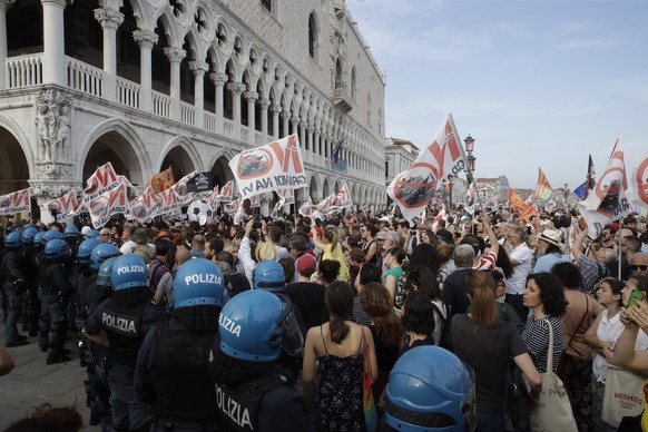 Demonstrators gather near St. Mark&#039;s Square during a protest against cruise ships being allowed in the lagoon, in Venice, Italy, Saturday, June 8, 2019. Venice environmentalists have long complai ...