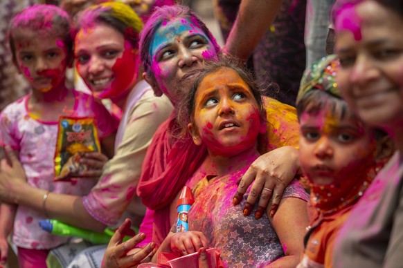 Indians smeared in color participate in Holi festival celebrations in Gauhati, India, Monday, March 29, 2021. Hindus threw colored powder and sprayed water in massive Holi celebrations Monday despite  ...
