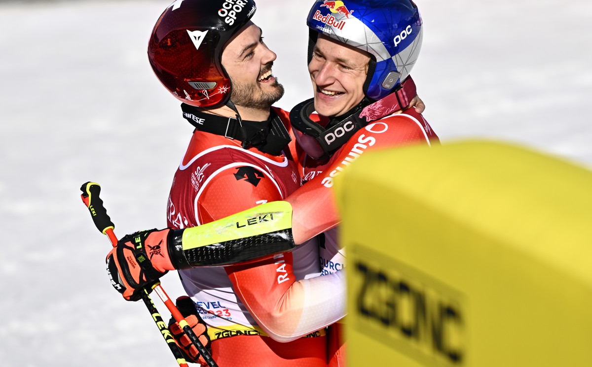 Winner Marco Odermatt of Switzerland, right, and second placed Loic Meillard of Switzerland, react after the men's giant slalom race at the 2023 FIS Alpine Skiing World Championships in Courcheve ...