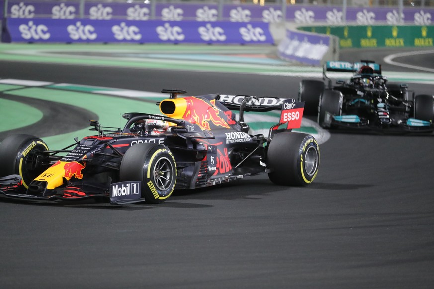 Red Bull driver Max Verstappen of the Netherlands in action in front of Mercedes driver Lewis Hamilton of Britain during the Formula One corniche circuit, in Jiddah, Saudi Arabia, Sunday, Dec. 5, 2021 ...