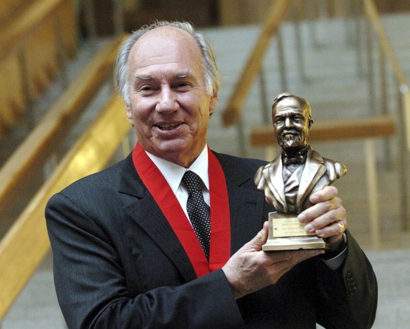 FILE - The Aga Khan holds the Andrew Carnegie Medal of Philanthropy after being presented with the prestigious award for philanthropy during a ceremony at the Scottish Parliament in Edinburgh, Scotlan ...