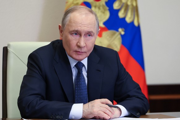 Russian President Vladimir Putin holds a meeting to discuss the situation in Dagestan hit by severe flood via videoconference at the Novo-Ogaryovo state residence outside Moscow, Russia, Tuesday, Apri ...