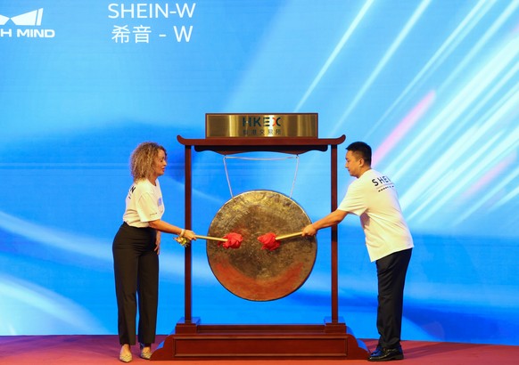 epa13203599 SHEIN employees strike a gong at SHEIN's listing ceremony at the Hong Kong Exchanges and Clearing Limited (HKEX) in Hong Kong, China, 01 September 2026. EPA/MAY JAMES