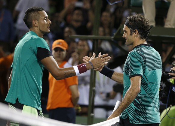 Roger Federer, of Switzerland, right, and Nick Kyrgios, of Australia, congratulate each other after Federer defeated Kyrgios 7-6 (9), 6-7 (9), 7-6 (5) during a tennis match at the Miami Open, Friday,  ...