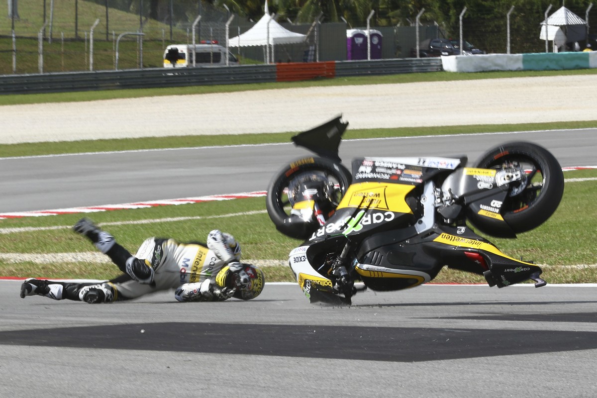 In this Saturday, Oct. 28, 2017, file photo, Switzerland's Moto2 rider Thomas Luthi crashes during the qualifying session of the Malaysia Moto2 at the Sepang International circuit in Sepang, Mala ...