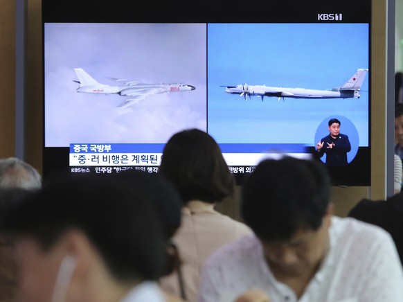 FILE - People watch a TV showing images of Russian Tu-95 bomber and Chinese H-6 bomber, left, during a news program at the Seoul Railway Station in Seoul, South Korea, Wednesday, July 24, 2019. South ...