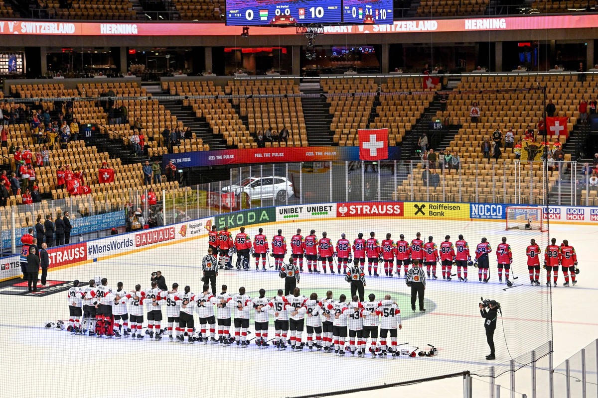 ODENSE, DENMARK - MAY 18: Swiss players listen to the national anthem during the 2025 Ice hockey, Eishockey World Championship, WM, Weltmeisterschaft match between Hungary and Switzerland at Jyske Ban ...