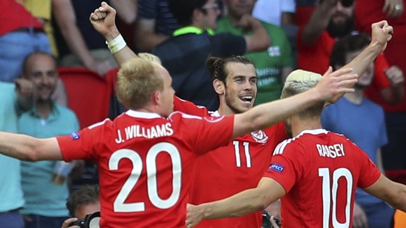 From left, Wales&#039;s Jonathan Williams, Wales&#039;s Gareth Bale and Wales&#039;s Aaron Ramsey celebrate after Northern Ireland&#039;s Gareth Mcauley, not in pic, scored a self goal, during the Eur ...