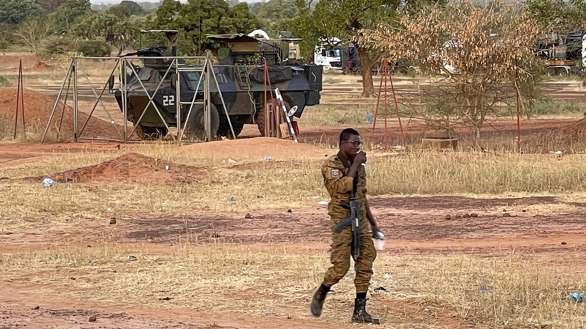 A Burkinabe soldier walks past a French Armoured Personnel Carrier part of a French military convoy heading to Niger, stopped by protesters in Kaya, Burkina Faso, Saturday Nov. 20, 2021. Residents of  ...