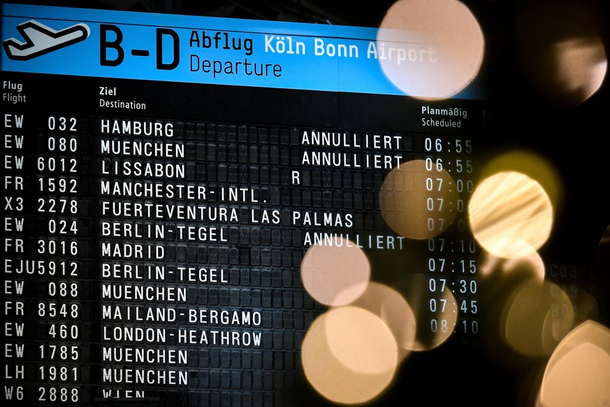 epa08094490 An electronic board displays cancelled flights of German airline Eurowings, at the Cologne Bonn Airport in Cologne, Germany, 30 December 2019. German airline Eurowings has cancelled more t ...