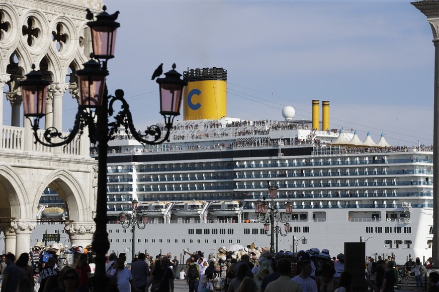 FILE-- A cruise ship passes by St. Mark&#039;s Square filled with tourists, in Venice, Italy, Sunday, June 2, 2019. Declaring Venice&#039;s waterways a �??national monument,�?� Italy is banning mammot ...