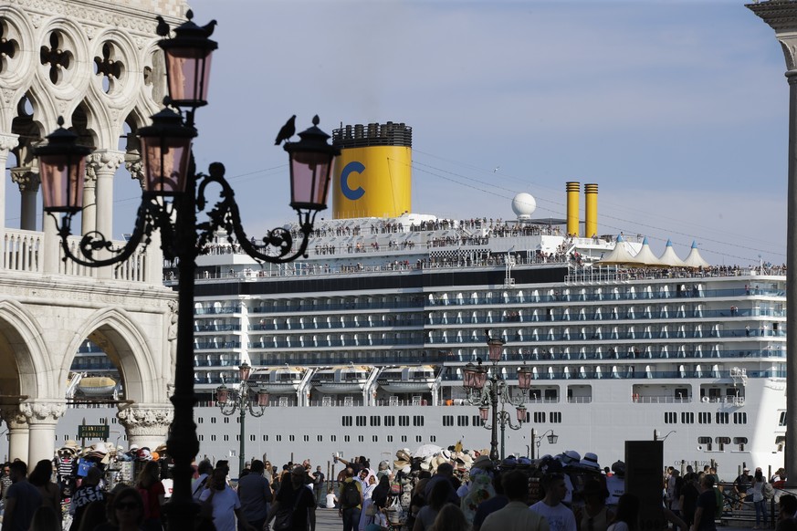 FILE-- A cruise ship passes by St. Mark's Square filled with tourists, in Venice, Italy, Sunday, June 2, 2019. Declaring Venice's waterways a �??national monument,�?� Italy is banning mammot ...