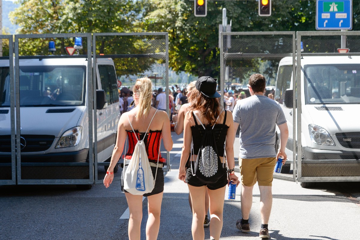 Participants walk towards police vehicles at the annual technoparade "Street Parade" in the city center of Zurich, Switzerland, Saturday, 13 August, 2016. Hundreds of thousands of ravers par ...