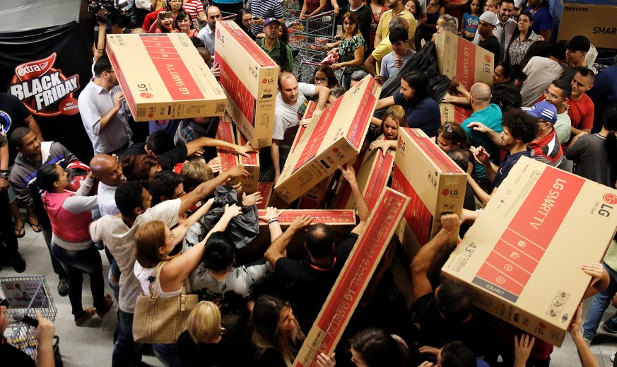 Shoppers reach for television sets as they compete to purchase retail items on Black Friday at a store in Sao Paulo, Brazil, November 24, 2016. REUTERS/Nacho Doce