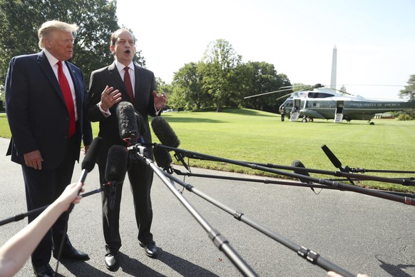 President Donald Trump and Labor Secretary Alex Acosta, speak to members of the media on the South Lawn of the White House, Friday, July 12, 2019, before Trump boards Marine One for a short trip to An ...