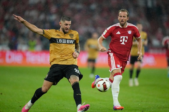 Bayern's Harry Kane, right, and Stuttgart's Jeff Chabot challenge for the ball during the Bundesliga soccer match between Bayern Munich and VfB Stuttgart in Munich, Germany, Friday, Aug. 28, ...