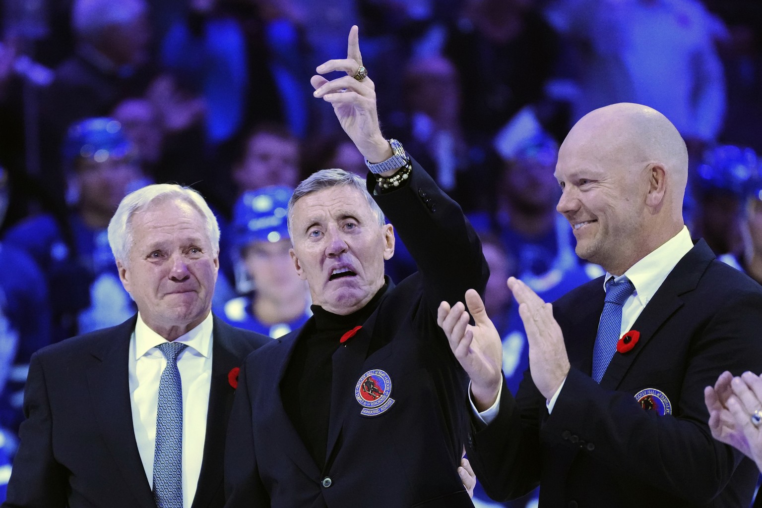 FILE - Former Toronto Maple Leafs players and members of the Hockey Hall of Fame, Darryl Sittler, Borje Salming and Mats Sundin, from left, take part in a ceremony before an NHL hockey game between th ...