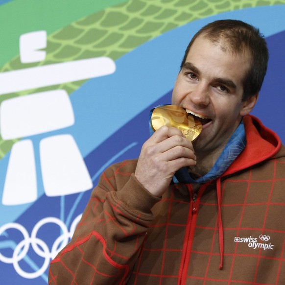 Didier Defago of Switzerland, gold medal winner of men's downhill race, poses before a media conference during the XXI Olympic Winter Games Vancouver 2010 in Whistler Creekside, British Columbia, ...
