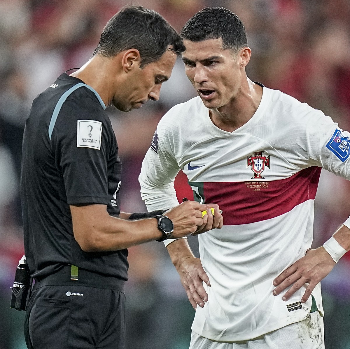 Portugal's Cristiano Ronaldo, right, talks with the referee Facundo Tello from Argentina during the World Cup quarterfinal soccer match between Morocco and Portugal, at Al Thumama Stadium in Doha ...