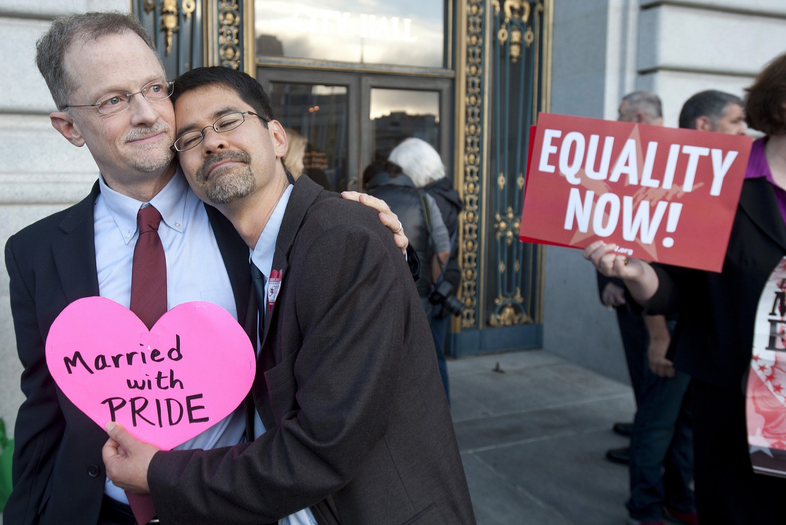 John Lewis, left, and Stuart Gaffney embrace outside San Francisco&#039;s City Hall shortly before the U.S. Supreme Court ruling cleared the way for same-sex marriage in California on Wednesday, June  ...