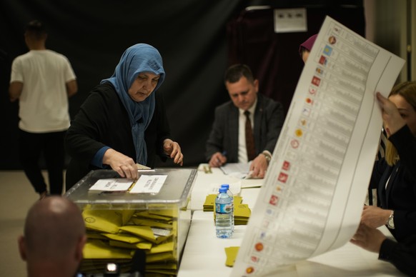 A woman votes at a polling station in Istanbul, Turkey, Sunday, May 14, 2023. Voters in Turkey go to the polls on Sunday for pivotal parliamentary and presidential elections that are expected to be ti ...