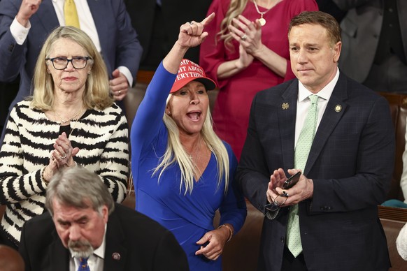 epa11941200 Republican Congressman Marjorie Taylor Greene of Georgia heckles Democrats during President Donald Trump's address to a joint session of the United States Congress in the House Chambe ...