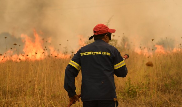 epa10830807 Firefighters operate during a wildfire in the area of Giannouli, Evros region, northern Greece, 31 August 2023. The Fire Brigade continues to battle fires in the wider area of Evros. Local ...
