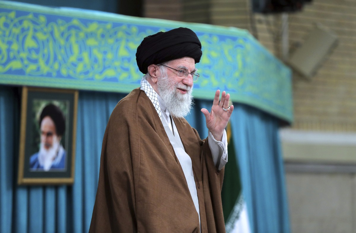 In this photo released by an official website of the office of the Iranian supreme leader, Supreme Leader Ayatollah Ali Khamenei waves to the crowd in a meeting in Tehran, Iran, Sunday, Oct. 27, 2024. ...