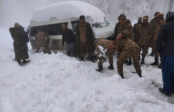 In this photo provided by the Inter Services Public Relations, army troops take part in a rescue operation in a heavy snowfall-hit area in Murree, some 28 miles (45 kilometers) north of the capital of ...