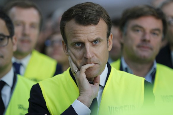 French President Emmanuel Macron listens to employees during a visit at the Whirlpool factory in Amiens, France, Tuesday, Oct. 3, 2017. Macron visits an ailing Whirlpool dryer factory in northern Fran ...